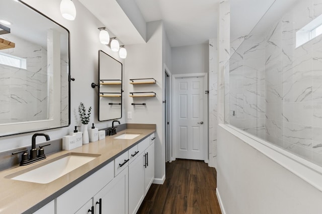 3409 Anchor Bay Trl, Lakewood Ranch, FL 34211 - bathroom with double vanity, a marble finish shower, wood finished floors, and baseboards