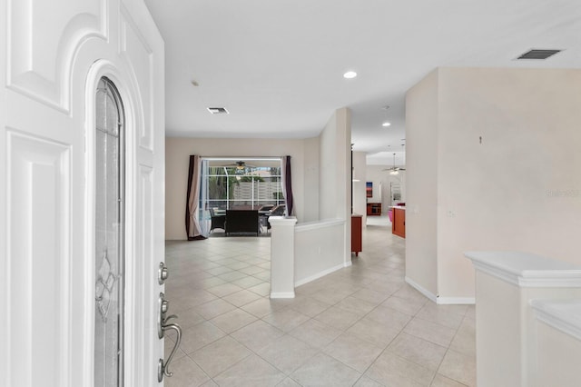 tiled foyer entrance with ceiling fan