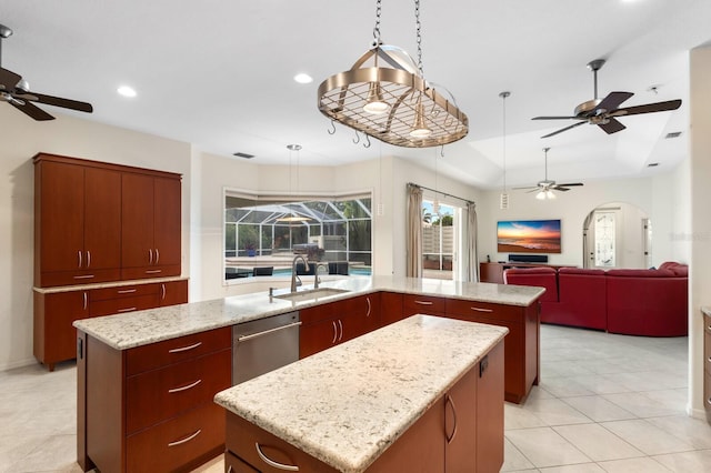 kitchen featuring stainless steel dishwasher, decorative light fixtures, sink, and a kitchen island