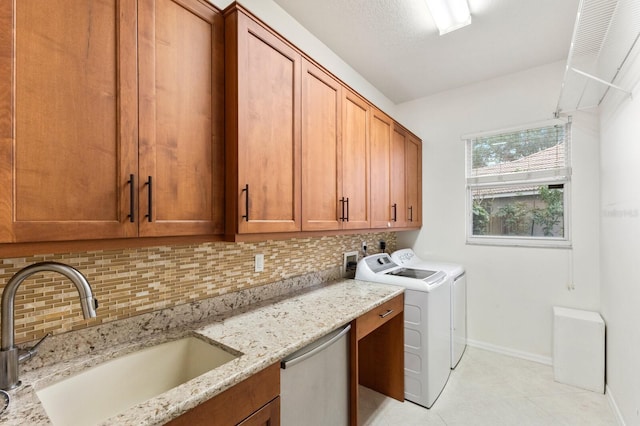 laundry area with cabinets, sink, and separate washer and dryer