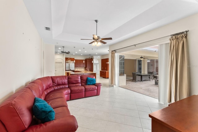 living room with ceiling fan and light tile patterned floors