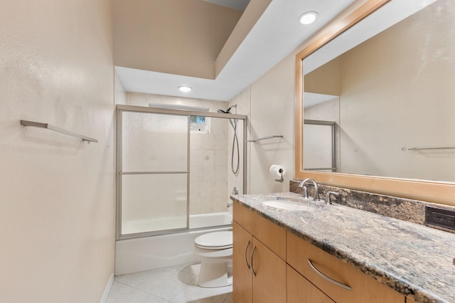 full bathroom featuring toilet, tile patterned flooring, enclosed tub / shower combo, and vanity