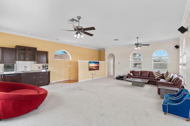 living room featuring light carpet, ceiling fan, sink, and crown molding