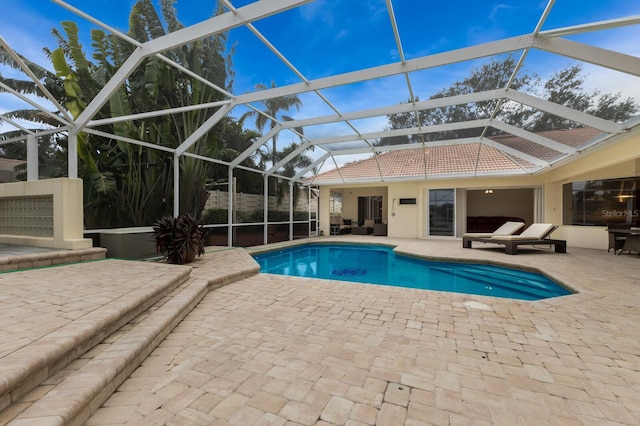 view of swimming pool featuring a patio and glass enclosure