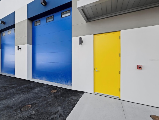 doorway to property featuring stucco siding