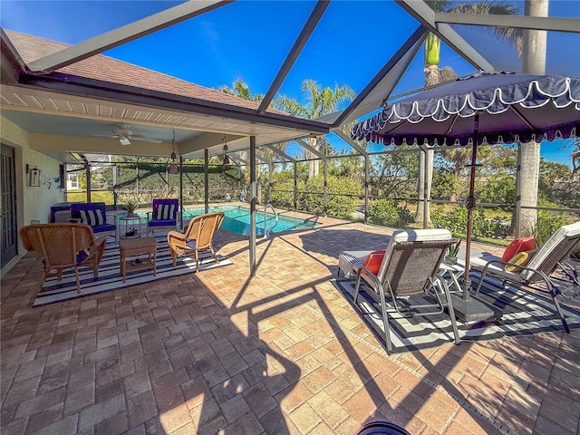 view of patio / terrace featuring ceiling fan and glass enclosure