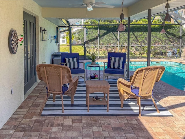 view of patio / terrace with ceiling fan and glass enclosure