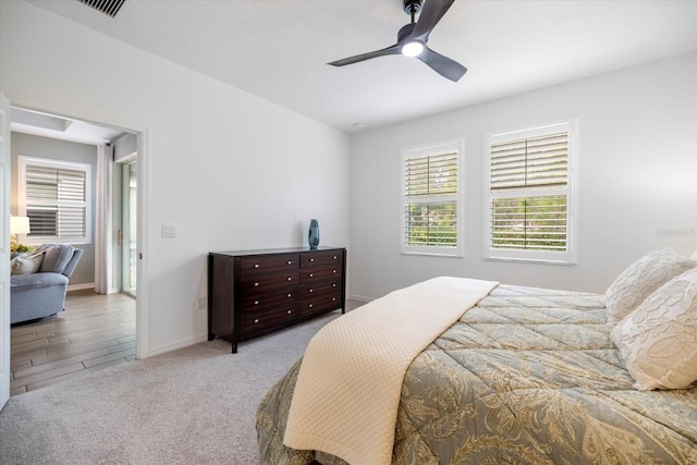 bedroom featuring light carpet and ceiling fan