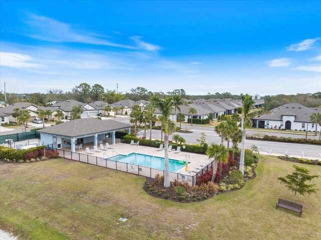 view of pool with a lawn and a patio