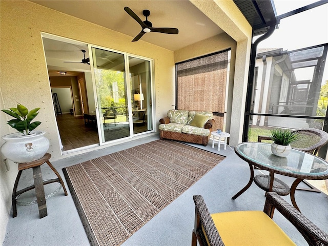 sunroom featuring a ceiling fan