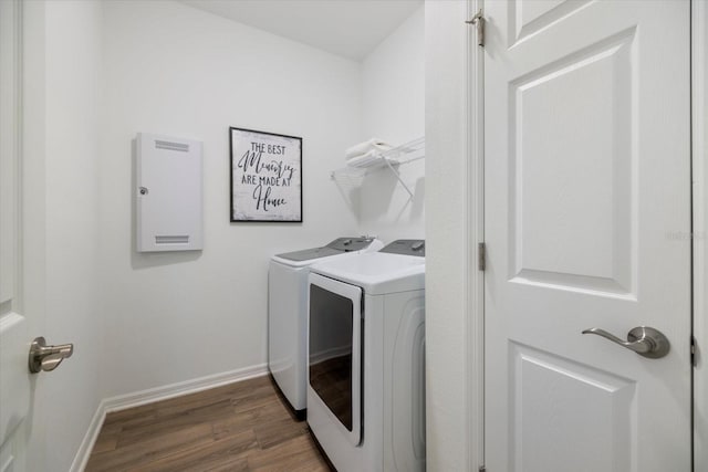 laundry room with laundry area, washer and dryer, baseboards, and wood finished floors