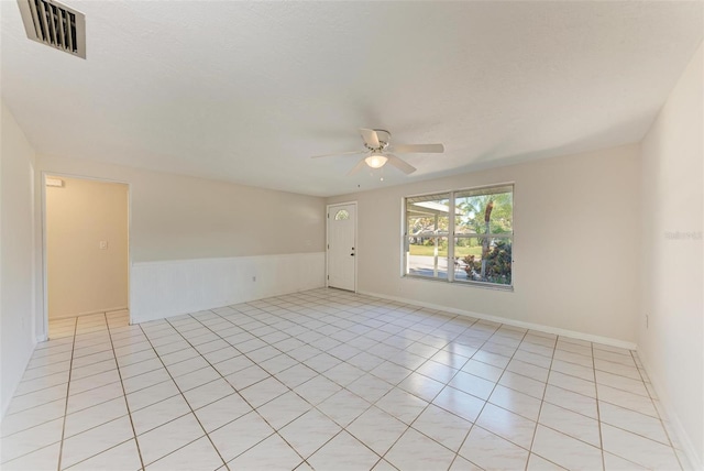 unfurnished room featuring ceiling fan and light tile patterned flooring