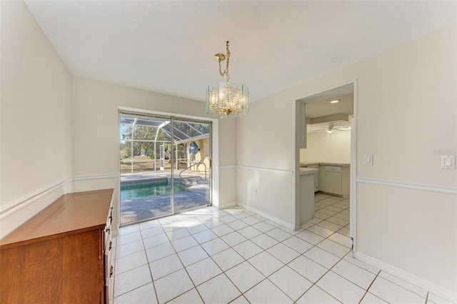 unfurnished dining area with light tile patterned floors and ceiling fan with notable chandelier