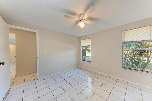 empty room featuring ceiling fan and light tile patterned floors