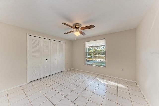 unfurnished bedroom with ceiling fan, a closet, and light tile patterned flooring