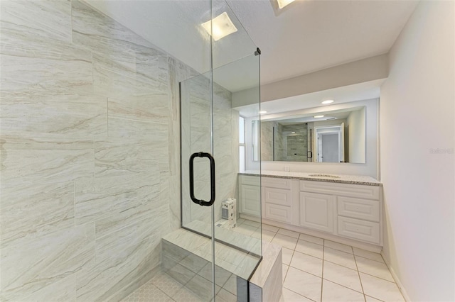 bathroom with vanity, tile patterned floors, and a shower with door