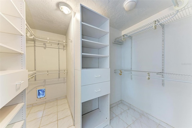 walk in closet featuring light tile patterned floors