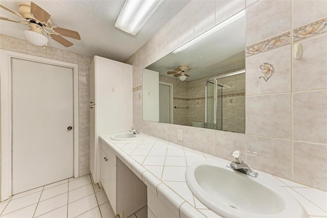 bathroom featuring tile patterned floors, vanity, and an enclosed shower