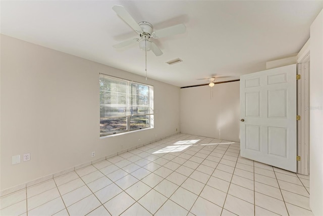 empty room featuring ceiling fan and light tile patterned floors