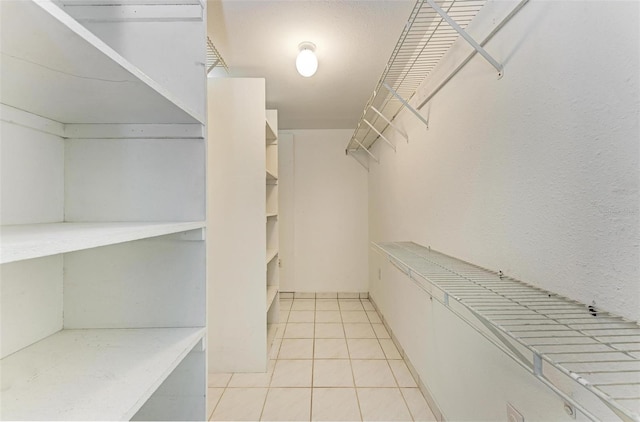 spacious closet featuring light tile patterned flooring