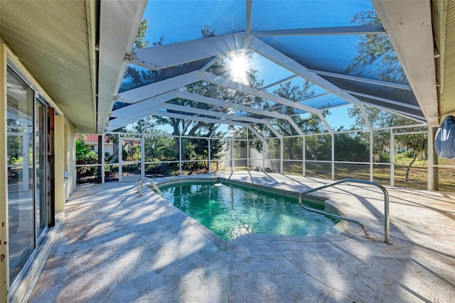 view of swimming pool featuring a lanai and a patio