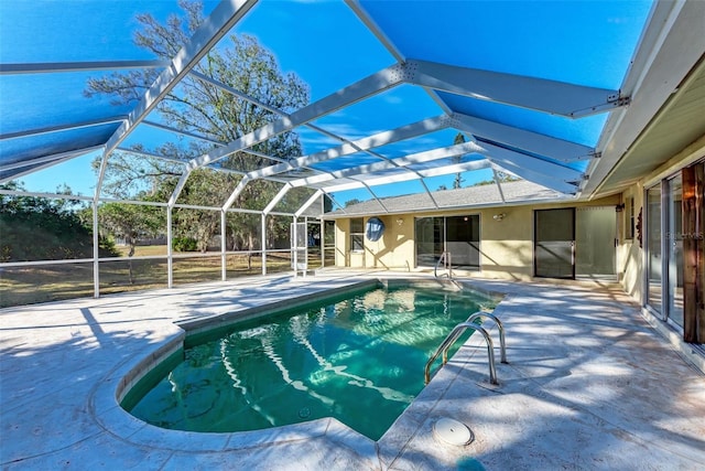 view of swimming pool featuring a lanai and a patio