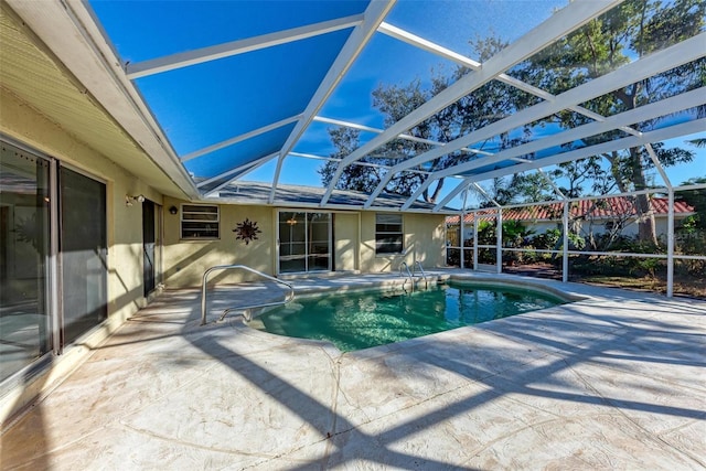 view of pool featuring a patio area and glass enclosure