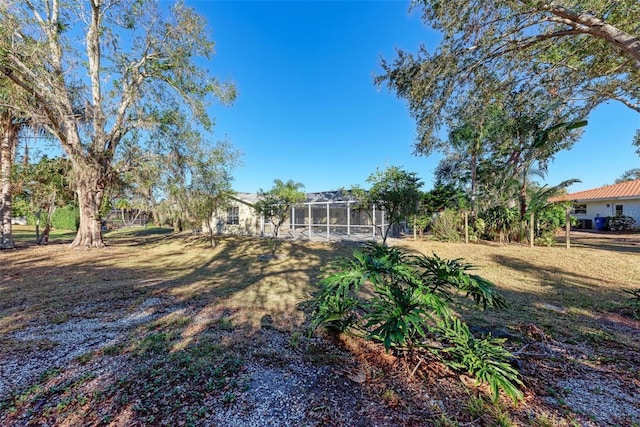 view of yard with glass enclosure