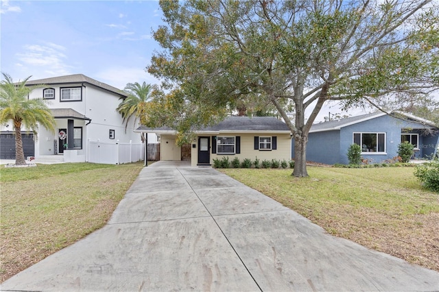 view of front facade with a front yard and concrete driveway