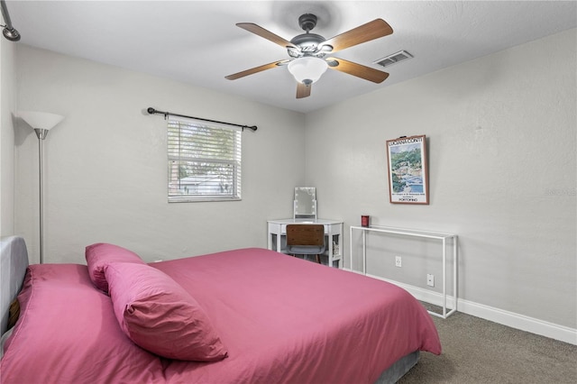 carpeted bedroom with a ceiling fan, visible vents, and baseboards