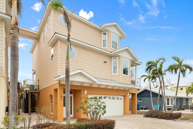 107 75th St, Holmes Beach, FL 34217 - view of front facade with a balcony and a garage
