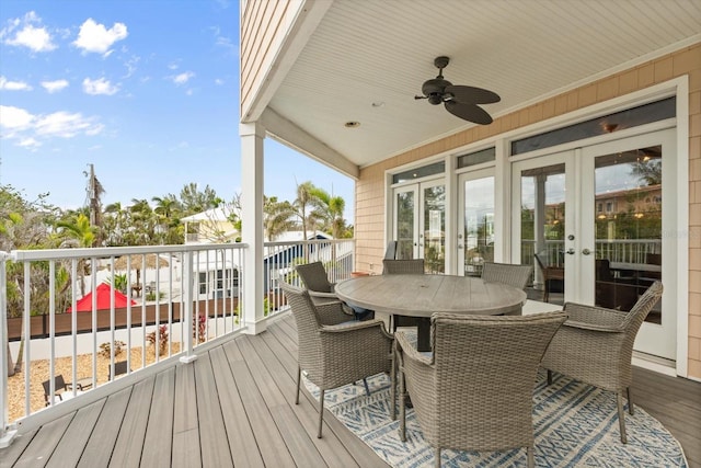 wooden deck with ceiling fan and french doors