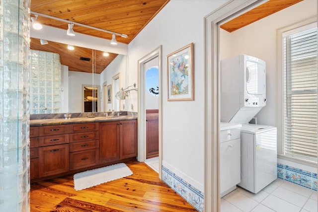 bathroom featuring wood ceiling, stacked washer / dryer, hardwood / wood-style flooring, and vanity