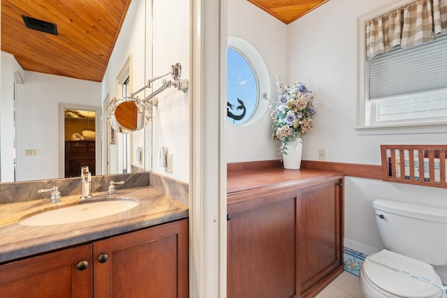 bathroom with tile patterned floors, vanity, toilet, vaulted ceiling, and wooden ceiling