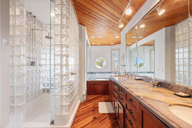 bathroom with plus walk in shower, wood ceiling, hardwood / wood-style floors, and vanity