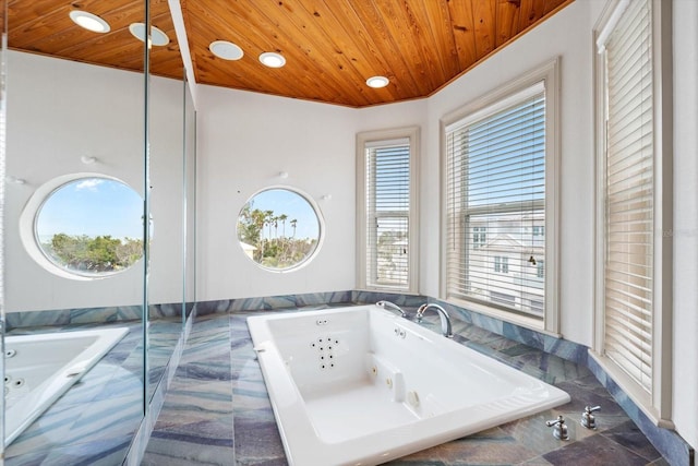 bathroom featuring wood ceiling and tiled tub