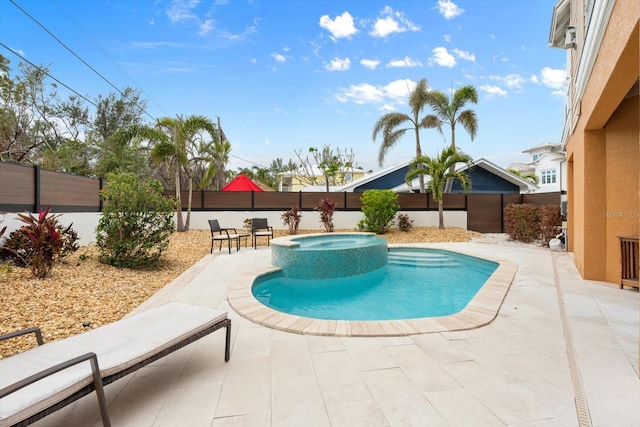 view of pool with a patio and an in ground hot tub