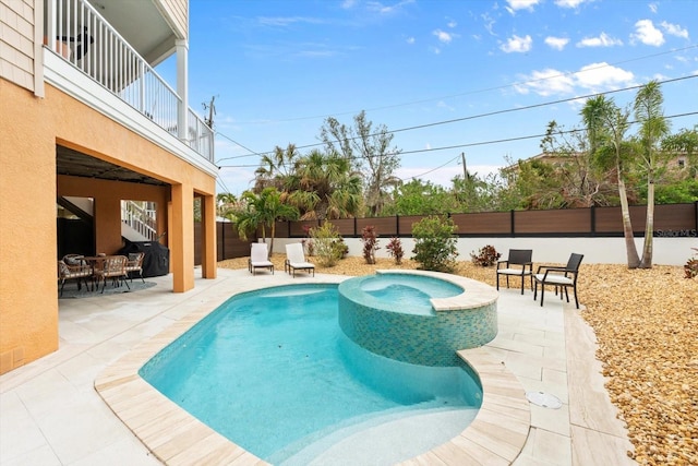 view of pool featuring a patio area and an in ground hot tub