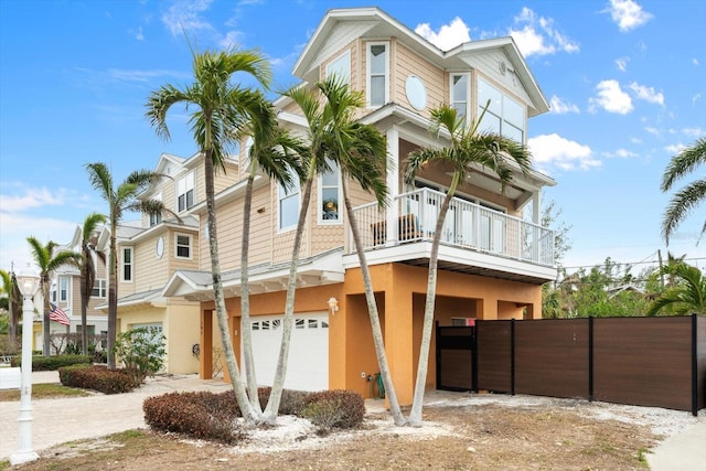 view of front of house featuring a garage and a balcony