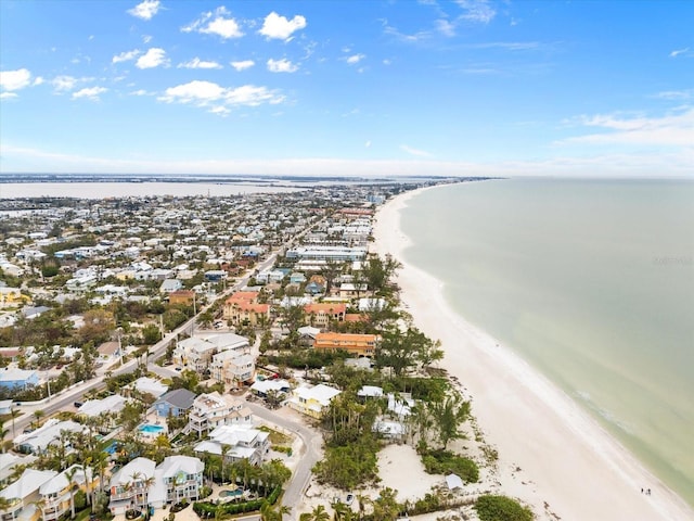 drone / aerial view featuring a beach view and a water view