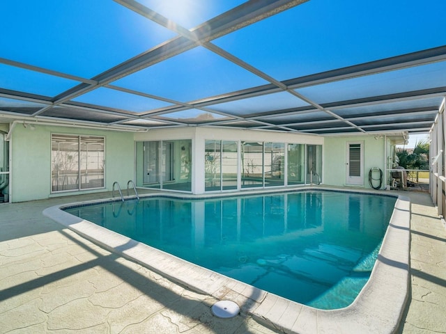 view of swimming pool with a patio area and glass enclosure