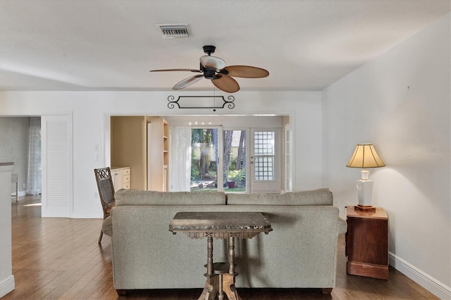 living room featuring ceiling fan and wood-type flooring