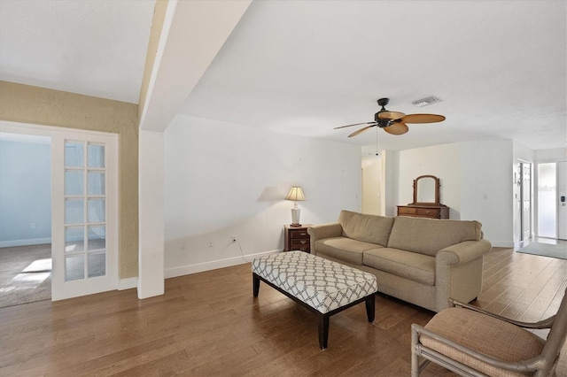 living room featuring ceiling fan and hardwood / wood-style floors