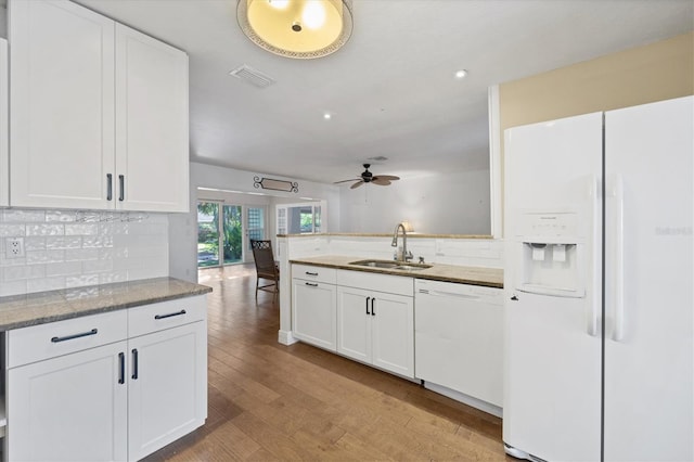 kitchen with sink, white appliances, and white cabinetry