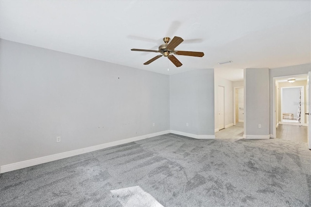 spare room featuring ceiling fan and light colored carpet