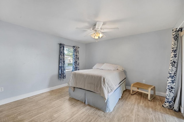 bedroom with ceiling fan and light hardwood / wood-style flooring