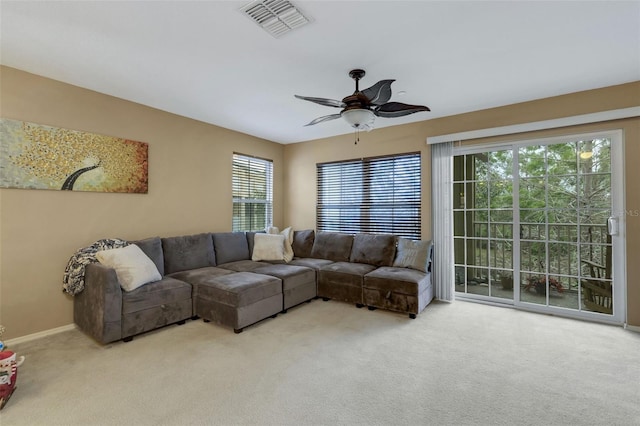 living room featuring light colored carpet and ceiling fan