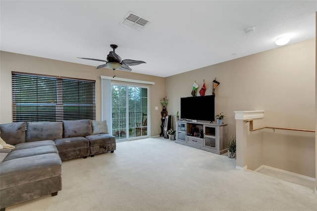 carpeted living room featuring ceiling fan