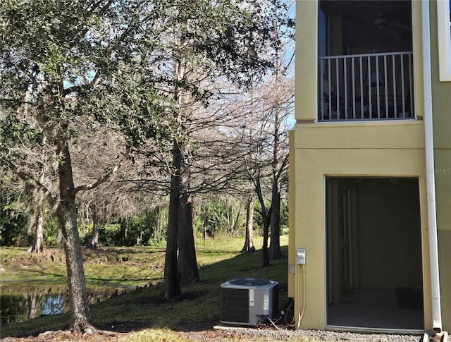 view of yard with central AC and a water view