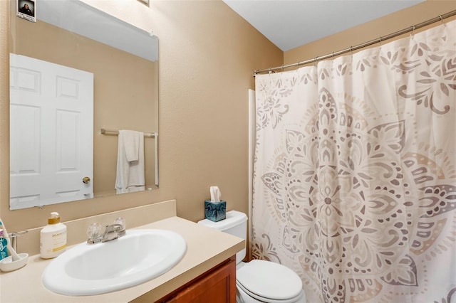 bathroom featuring vanity, a shower with curtain, and toilet